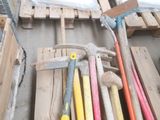 a pile of tools sitting on a pallet next to a pile of wooden pallets