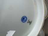 a white bowl with a blue sticker sitting on top of it