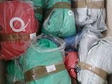 a cardboard box filled with many different colored blankets
