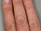 someone is holding a ring with a pink stone in it