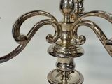 a silver candle that is sitting on a table