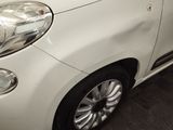 a close up of a white car parked in a garage