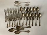 a lot of silver spoons and forks on the table