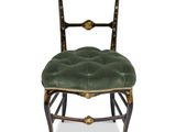 an image of a chair with a green seat and gold trim