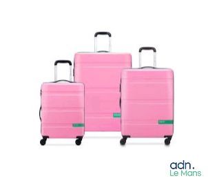 three pieces of pink luggage sitting next to each other on a white surface