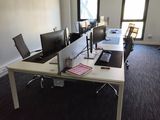 an image of an empty office with a desk and two monitors