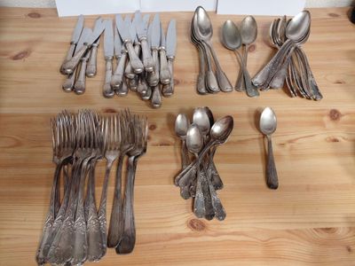 a lot of silver spoons and forks on the table