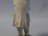 a small statue of a man in a hat and coat