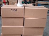 boxes stacked on top of a pallet with a hat on top of it
