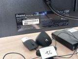 a computer monitor with a keyboard and a mouse on the desk