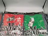 two t - shirts that are in a box on the table