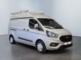 the white van is parked in a large room with a black floor