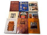 several books are stacked on top of each other on a white surface