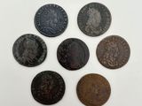 a group of six roman coins, one of which has a head of a lion