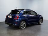 the back of a blue fiat suv parked in a garage