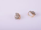 a pair of gold and diamond earrings on a white background