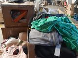 a pile of clothing on a carton in a warehouse