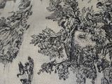 a black and white toile fabric with birds and trees on it