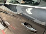 a car that has a broken door handle on the side of the road
