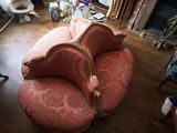 une chaise rose qui se trouve dans un salon