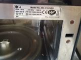 a close up of a microwave with a metal pan inside of it