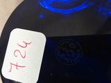 a blue glass plate with a sticker on it