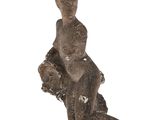 an image of a statue of a woman sitting on a rock