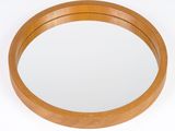 an image of a round wooden mirror on a white background