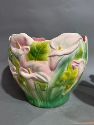 two vases that have flowers on them on a table