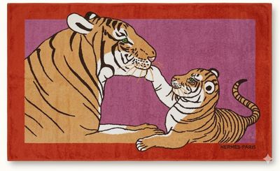 an orange rug with a tiger and a baby tiger on it