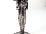 a silver candle holder with two candles on it