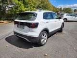 the rear end of a white volkswagen suv parked in a parking lot
