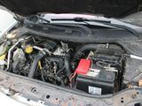 the engine of a car with its hood open and a car battery in it
