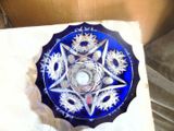 a blue glass plate with a star design on it
