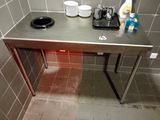 a metal table with plates and cups on it in a bathroom