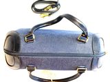 a blue bag with a black handle on a white background