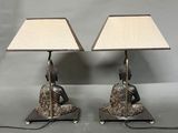 pair of bronze table lamps with a bird on a rock base