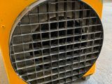 a yellow heater that is sitting on the floor