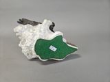 a small piece of rock with a green patch on it