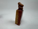 a small statue of a man with a hat on it ' s head
