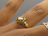 a woman ' s hand with a gold ring on it