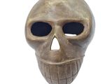 a bronze skull with a black eye on a white background