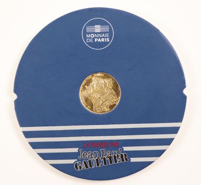 the coin is in a blue box with a white stripe around it