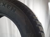 an image of a tire on a white surface with a light behind it