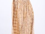 an image of a dress hanging on a hanger on a white wall