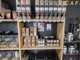 a wooden shelf filled with lots of different types of coffee
