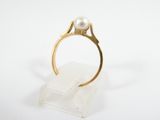 an image of a gold ring with a pearl in it