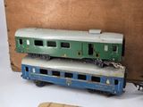 two toy trains sitting next to each other on a table