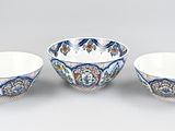 two bowls and a bowl are sitting side by side on a gray surface