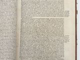an open book on a white table with a black and white picture